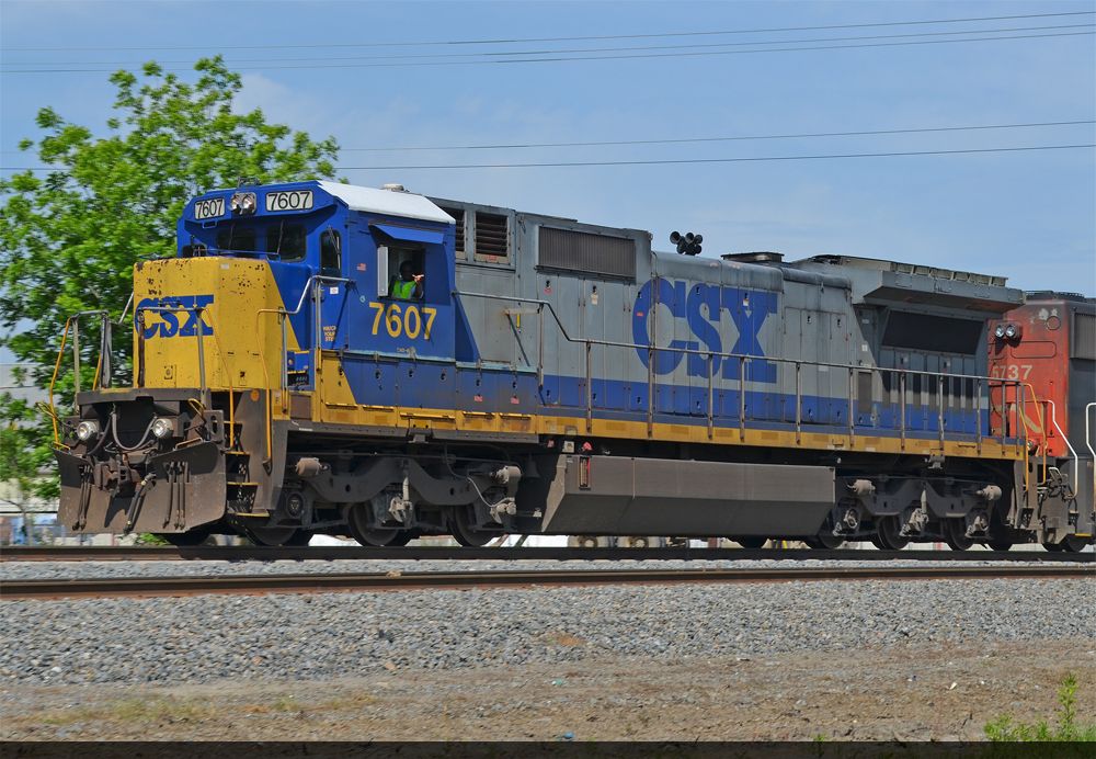 The conductor of CSX 7607 gives a friendly wave